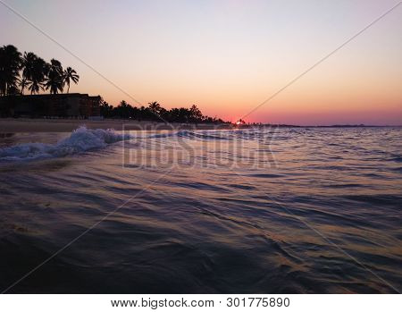 Por Do Sol.
Watching The Sunset From Within The Sea, Reddish Sky.