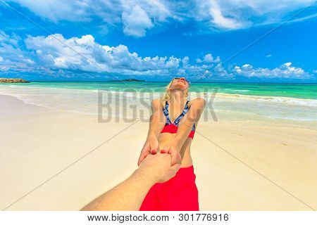 Follow Me. Happy Tourist Woman In Bikini Holding Hand Of Her Partner At Seychelles, Indian Ocean. Be