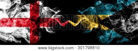 English Vs Bahamas, Bahamian Smoky Mystic Flags Placed Side By Side. Thick Colored Silky Smokes Flag