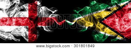 English Vs Guyana, Guyanese Smoky Mystic Flags Placed Side By Side. Thick Colored Silky Smokes Flag 