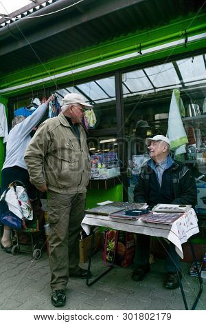 Krakow, Poland - September 21, 2018:  Polish Buyer Bargaining With A Old Coin Seller At Krakows Unit