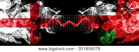 English Vs Oman, Omani Smoky Mystic Flags Placed Side By Side. Thick Colored Silky Smokes Flag Of En