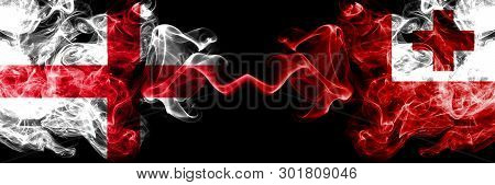 English Vs Tonga, Tongan Smoky Mystic Flags Placed Side By Side. Thick Colored Silky Smokes Flag Of 