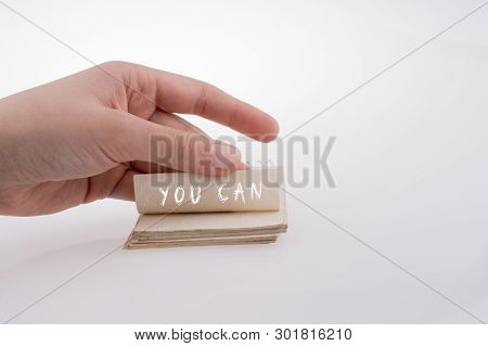 Hand Holding Paper With Note You Can On A White Background