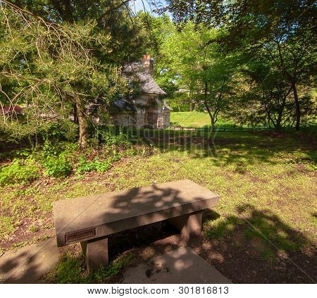 A Stone Bench In The Shade Next To The Gate House In Frick Park, Located In Pittsburgh, Pennsylvania