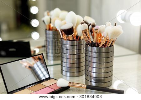 Palette With Shadows And Brushes On The Table In The Beauty Salon