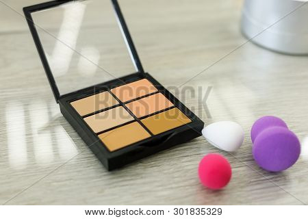 Palette With Shadows And Sponge On The Table In The Beauty Salon