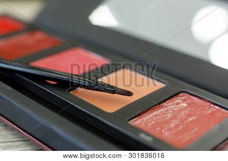 Palette With Lip Gloss, Brush On The Table In The Beauty Salon