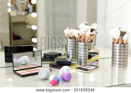 Palette With Shadows, Brushes And Sponges On The Table In The Beauty Salon