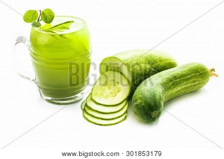 Raw Extracted Cucumber Juice In A Transparent Glass Isolated On White Along With Raw Fresh Cucumber 