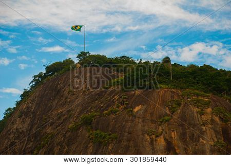 Rio De Janeiro, Lama Beach, Brazil: Beautiful Landscape With Mountain And Beach. Flag Of Brazil On T