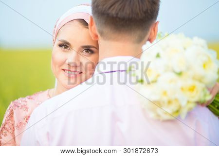 National Wedding. Bride And Groom In Field. Wedding Muslim Couple During The Marriage Ceremony. Musl