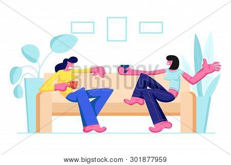 Couple Of Girl Friends Sitting On Couch, Drinking Beverages And Communicating At Home. Female Charac