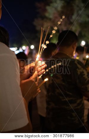 Unidentify People With Lighted Candles In Hand During Buddhist Ceremony.