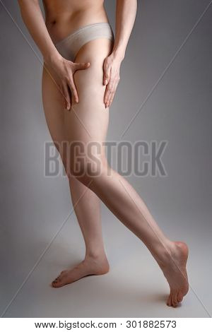 The Woman Shows A Smooth And Delicate Skin On Her Legs. The Concept Of Aesthetic Medicine And Skin I