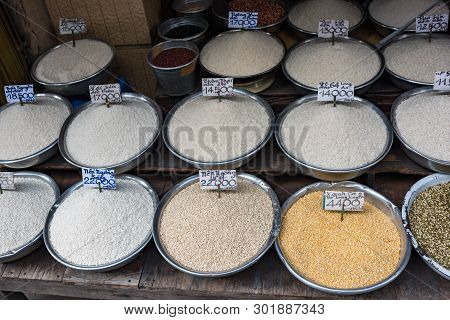 Different Types Of Rice In Bowls For Sale On Farmers Market In Vietnam. Street Food Stall Display