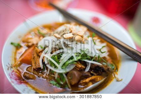 Close Up Of Traditional Vietnamese Pho Soup In A Bowl With Wooden Chopsticks. Authentic Vietnamese C