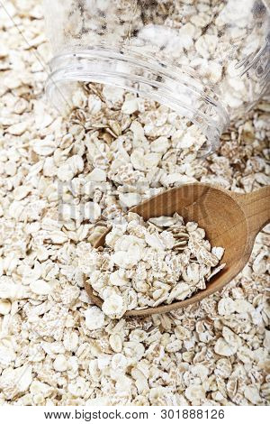 Raw Oatmeal With A Spoon On The Table. Traditional Carbohydrate Breakfast