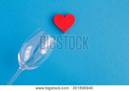 Red Heart And  Empty Wine Glass On The Blue Background.top View.copy Space.closeup.