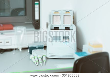 Part Of Modern Scientific Laboratory With Pcr Machine For Dna Amplification On Work Bench.