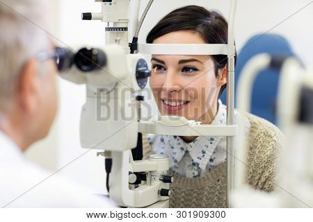 Female patient is on ophthalmoscope apparatus for review eyes