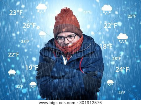 Young man freezing in warm clothing with weather condition and forecast concept