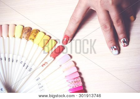 Woman Choose The Color Of Polish For Manicure. Design For Nails. Testers Nail Polish.fashion Manicur