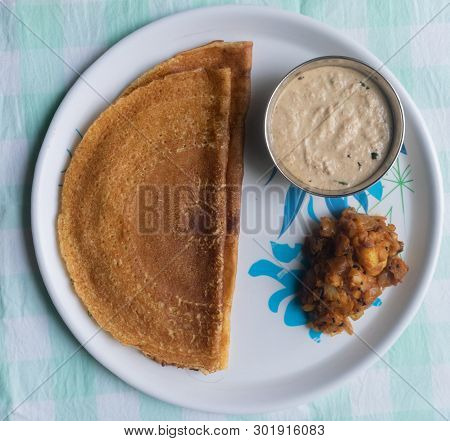 Maida Dosa With Coconut Chutney And Potato Or Aloo Currey In Plate