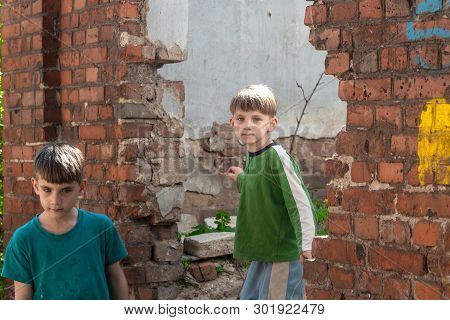 Children In An Abandoned House, Two Poor Abandoned Boys, Orphans As A Result Of Natural Disasters An