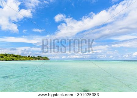 Beautiful Tropical Nature Landscape Of Clear Sea Near The Beach, Green Island, White Cloud And Blue 
