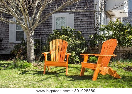 Adirondack Beach Chair Near The House With Grass In Provincetown (cape Cod). Concept Of Perfect Calm