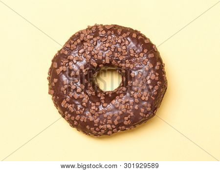 Single Chocolate Donnut On A Yellow Background