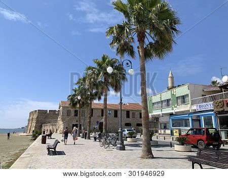 Larnaka, Cyprus - May 11, 2019: Finikoudes Embankment And Medieval Fortress On The Mediterranean Coa