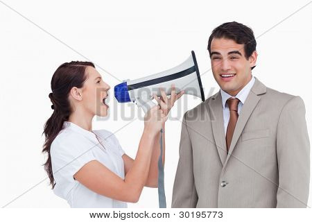 Saleswoman with megaphone yelling at colleague against a white background