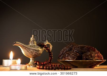Ramadan Food And Drinks Concept. Ramadan Lantern With Arabian Lamp, Wood Rosary, Tea, Dates Fruit An