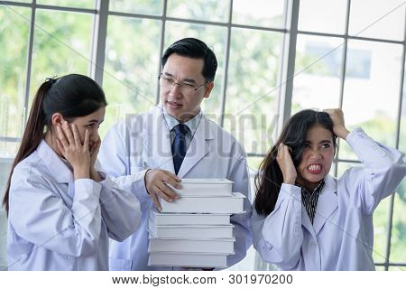 Senior Asian Scientist Has Assigning New Job To Students In Laboratory.