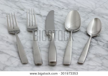 Beautiful Silverware On Carrara Marble