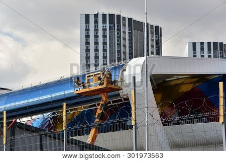 April 28, 2018. Russia. Krasnoyarsk. Tho Builders Worker Installing Front Panels On Facade Of Modern