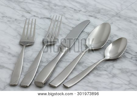 Beautiful Silverware On Carrara Marble