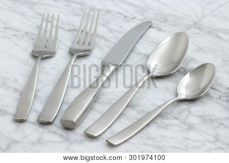 Beautiful Silverware On Carrara Marble
