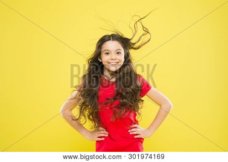Girl Adorable Kid Long Wavy Hair Yellow Background. Strong Persistent Winds Can Create Tangles And S