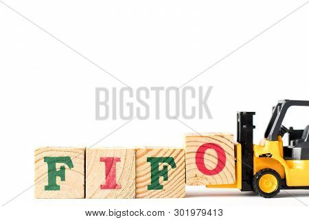 Toy Forklift Hold Letter Block  To Complete Word Fifo (abbreviation Of First In First Out) On White 