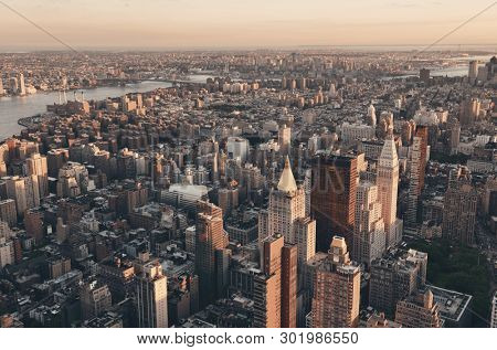 New York City rooftop view with downtown Manhattan skyscrapers and urban cityscape.