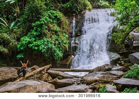 Women Travel. Woman Asia Travelers Travel Nature Forests, Mountains, Waterfalls. Travel Siliphum Wat