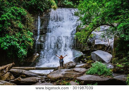Women Travel. Woman Asia Travelers Travel Nature Forests, Mountains, Waterfalls. Travel Siliphum Wat