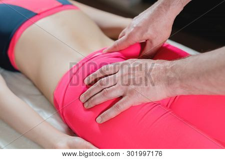 Close-up Of A Young Girls Spine Base Editing By A Male Physiotherapist Of Visceral Massage. The Hand