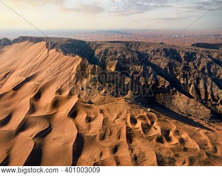 Scenic Fossil Rock In The Sharjah Desert Of The United Arab Emirates Aerial View. Sand Meeting The R