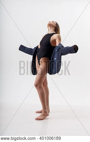 Portrait Of Young Attractive Asian Woman With Long Hair, Bare Feet In Black Bodysuit, Blue Suit Isol