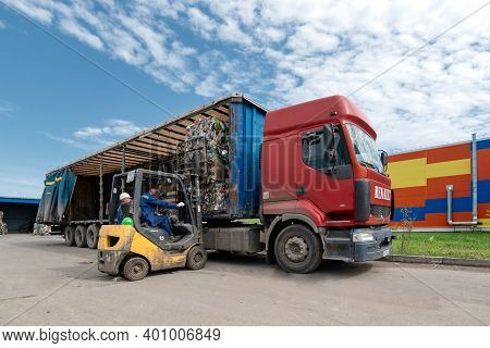 Gubkin, Russia - June 12, 2020: A Forklift Loads Bales Of Compressed Plastic Bottles Into A Truck Tr