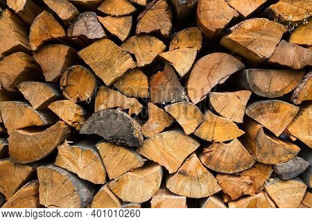 Background Of Dry Chopped Firewood Logs Stacked Up On Top Of Each Other